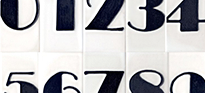 Black art deco numbers on a white board