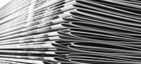 A stack of white A4 booklets whick have been staple bound