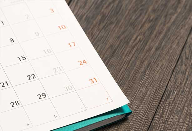 An A4 calendar on wooden desk