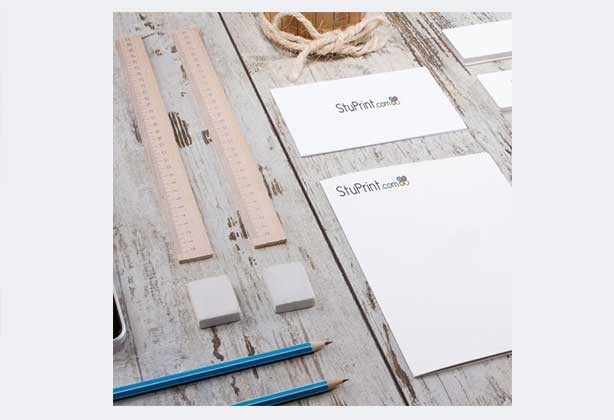 Letterheads lying on an office desk with StuPrint logo