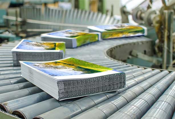 Stacks of A5 leaflets coming off the lithographic press